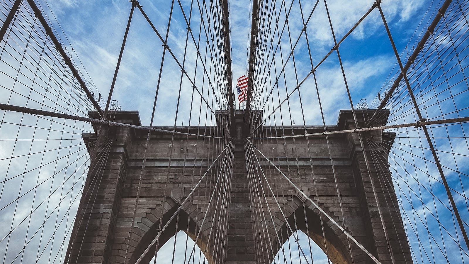 The Brooklyn Bridge tower and its radiating suspension cables, seen from below.